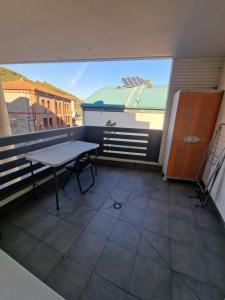 a balcony with a table and a view of a building at Castro Urdiales Mioño in Mioño