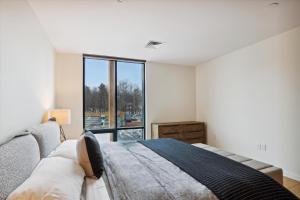 a bedroom with a bed and a large window at Treehouse at Spruce Peak in Stowe