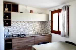 a kitchen with a sink and a counter top at Casa Moderna in Olbia