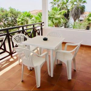 a white table and chairs on a balcony at Island Oasis at Tortuga Beach - 487 in Prainha
