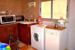 A kitchen or kitchenette at HN Home House with air conditioning