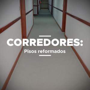 a corridor of an empty room with the wordscorporate at Blumenau Tower by Castelo Itaipava in Blumenau