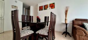 a dining room with a glass table and two chairs at CB2 Apto tranquilo con Aire Acondicionado in Neiva