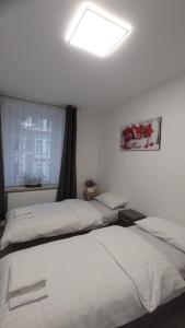 two beds sitting next to each other in a bedroom at CT Apartment Wurzen in Wurzen +25 photos