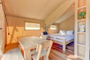 a bedroom with a bed and a table in a tent at 12 Fires Luxury Glamping with AC #2 in Johnson City