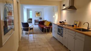 a kitchen and living room with a couch and a table at La Villa Bellevue Anduze in Anduze