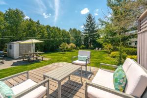 a backyard with a wooden deck with a table and chairs at Boho Inspired NOTL Wine Country Private Home for 2 in Niagara-on-the-Lake