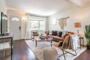 a living room with a couch and a table at Boho Inspired NOTL Wine Country Private Home for 2 in Niagara-on-the-Lake