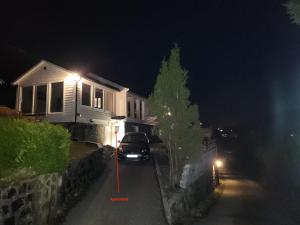 a car parked in front of a house at night at Fjordclaw SNM- adjoining the Bergen city & Nature in Bergen