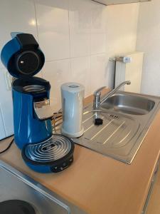 a coffee maker sitting on a counter next to a sink at No.5 - Apartmenthaus in Stein in Stein