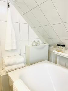 a white bathroom with a tub and a sink at Central Economic Stavanger Kongsteinsgata in Stavanger