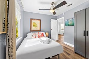 a bedroom with two beds and a ceiling fan at 2 BR 3 BD Popular House by Austin Downtown and 6th Street in Austin
