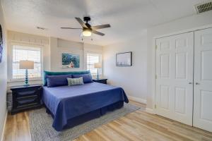 a bedroom with a blue bed and a ceiling fan at Waterfront Kingston Apartment with River Access! in Kingston