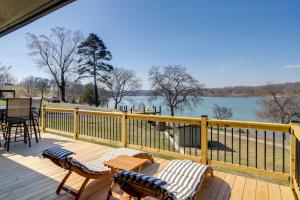 a deck with chairs and tables and a view of the water at Waterfront Kingston Apartment with River Access! in Kingston