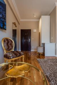 a living room with two chairs and a glass table at San Mihael luxury rooms 2 in Dugopolje