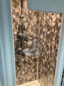 a shower in a bathroom with a tiled wall at Abingdon Lodge Hotel in Ryde