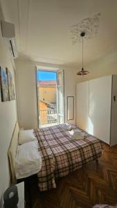 a bedroom with a bed and a window at Appartamenti Fiore in Sanremo
