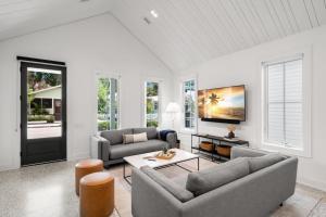 a living room with two couches and a table at Casa Cohiba - Ybor City Townhouse in Tampa