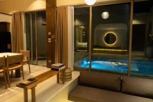 a room with a hot tub in a building at Seamira House Huahin - SHA in Hua Hin