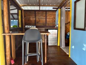 a bar in a tiny house with a chair at Rangiroa Bliss in Tiputa