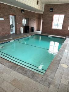 a swimming pool with blue water in a building at Microtel Inn & Suites by Wyndham Amarillo in Amarillo