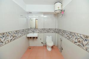 a bathroom with a toilet and a sink at Airport Plazzo Crown Haven Delhi in New Delhi