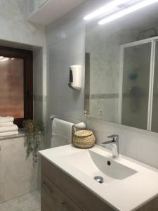 a bathroom with a sink and a mirror at La Paserina in Arenas de Cabrales