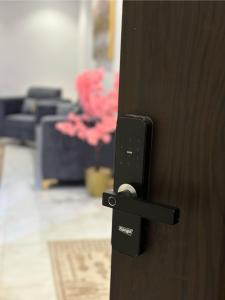 a black door knob on a wooden door at Roma house in Al Madinah