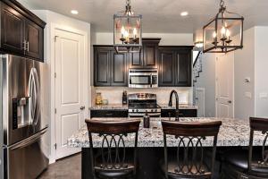 a kitchen with black cabinets and a granite counter top at Desert Cool in Ivins