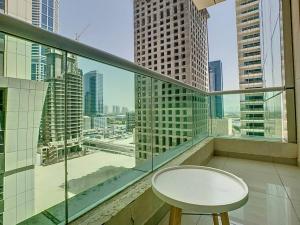 a balcony with a table and a view of a city at Key View - Marina Pinnacle in Dubai