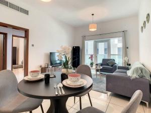 a living room with a table and chairs at Key View - Marina Pinnacle in Dubai