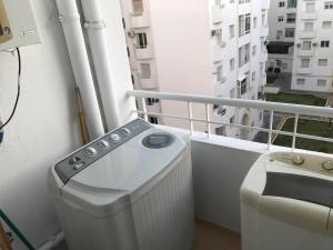 a washing machine on a balcony of a building at Le Narjess Appartement Tunis in Tunis