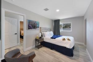 a hotel room with a bed and a chair at Palm Cove Motel in Clearwater