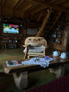 a room with a wooden table in a cabin at Black Wood in Žabljak