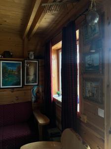 a room with a chair and a window in a cabin at Black Wood in Žabljak
