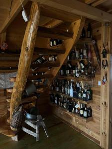 an attic room with a bunch of bottles on shelves at Black Wood in Žabljak