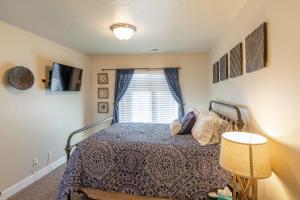 a bedroom with a bed and a window at Desert Dream in St. George +28 photos
