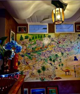 a map on the wall of a restaurant at Hôtel Riad Atlas Dades in Boumalne