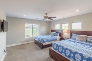 a bedroom with two beds and a ceiling fan at 18th Fairway to Heaven in St. George