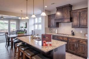 a kitchen with wooden cabinets and a large kitchen island at 18th Fairway to Heaven in St. George