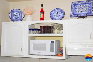 a kitchen with blue and white dishes and a microwave at Marina Pinacate B-408 in Puerto Peñasco