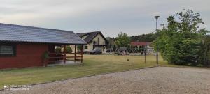 a yard with a playground and a house at Domki letniskowe "DORCIA" in Łeba