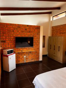 a room with a brick wall with a fireplace at DELUX in Tarapoto