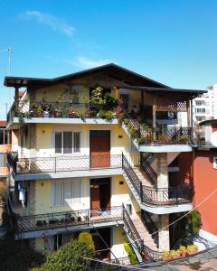 an apartment building with balconies and plants at Shkodra Hostel in Shkodër