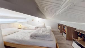 a bedroom with two beds with white sheets at Etoile de mer avec piscine in Brétignolles-sur-Mer +16 photos