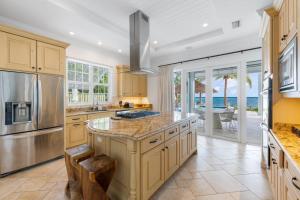 a kitchen with a large island and a view of the ocean at Kiboko in Midland Acres
