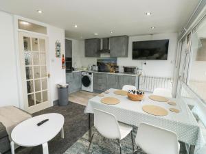 a kitchen and dining room with a table and chairs at Sunny View in Dawlish