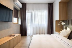 a hotel room with a bed and a window at Pitar Mos - Downtown Bucharest in Bucharest