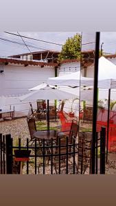 a table and chairs with white umbrellas at DELUX in Tarapoto