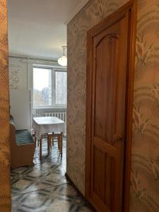 a door leading to a dining room with a table at Недорога квартира на Харківській, 32 in Sumy